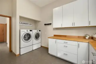 Next to the half bathroom is the spacious laundry room. The quality LG washer and dryer convey and cabinetry and countertops were recently installed for nice style and storage space.