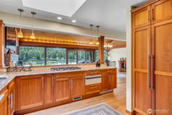 Gourmet Chef’s Kitchen is superb, granite countertops with travertine backsplash, undermount deep sink. Recessed ceiling light and pendant lighting over the island counter.  Custom Cherry cabinetry throughout. Superior S/S appliances include double door refrigerator/freezer, built-in counter gas 5-burner cooktop, Miele dishwasher, built-in Convection oven with microwave above and Thermador separate warming oven. Built in pantry cabinet with pull out shelving.