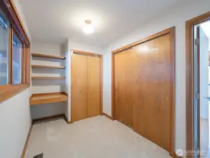 Bedroom 2 on main floor with built-in desk and shelving