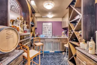 access to custom wine celler with crafted cabinetry w/inlays, wine storage and double sink.