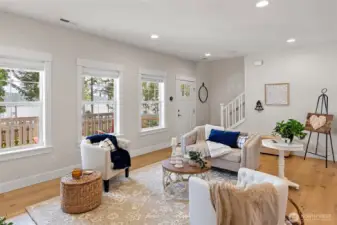 The stairway leads to the primary suite with a view of North Bay, and two additional bedrooms (3 total).