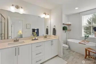 Primary bath with quartz contertips, soaking tub and subway tiled shower.