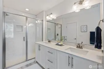 The bath countertops are quartz, and the shower features subway tiles.