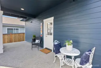 The back patio is partially covered, and the door leads to the kitchen for easy access.