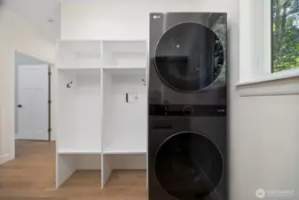 Come in from the garage to a nook to remove coats and shoes. Pop dirty items in the laundry.