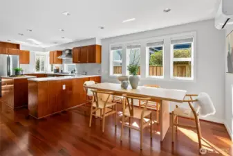 Natural light fills this home with an open living layout - kitchen, dining and living space surrounded by walls of windows.