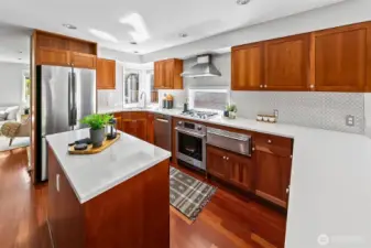 Updated kitchen shines with corner windows, tons of counter space, beautiful cabinets and gas cooktop.