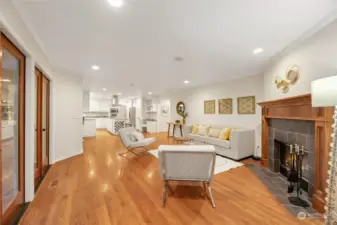 Open concept informal space with two sets of french doors, and cozy fireplace.