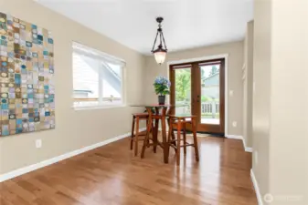 Dining area between living room and kitchen features beautiful wooden French doors!