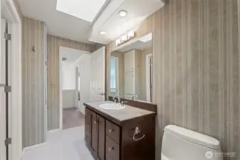 This upstairs bathroom is accessible from the hallway or spare bedroom. Lots of light from the skylight!