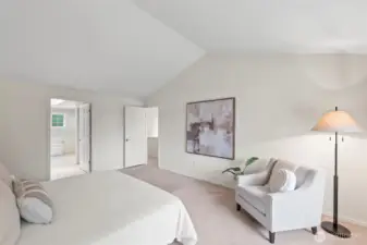 This primary suite lives large with vaulted ceilings and lots of natural light.