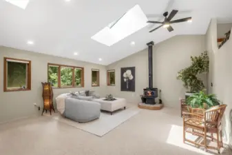 The living and dining rooms flow seamlessly together and offer a perfect environment for everyday living or entertaining, enhanced by the cozy ambiance of a wood-burning stove.