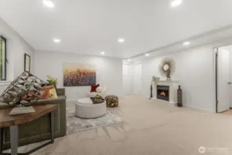 Gas fireplace on lower level in the family room. From this area, you have one door leading to the work shop area, and another leading to the unfinished part of the basement.