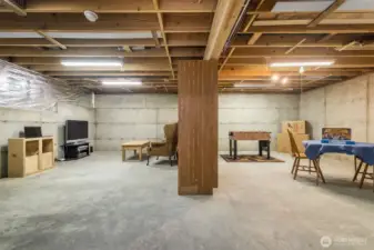 Approximately 700 square feet of this level remain unfinished, allowing you to tailor it to fit your lifestyle or future investment. One area currently functions as a workshop, complete with power, water at the sink, and built-in storage benches. With existing plumbing and a nearby 220-volt line, this space could be transformed into a second laundry room, mudroom, or hobby space.