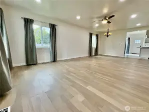 Large main living space with new engineered hardwood floors.