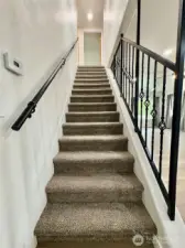 Custom handrail and new carpet leads  to the upper floor.