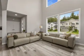 Soaring ceilings and walls of windows flood the space with natural light.