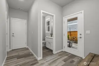 Directly after the great room you will find the powder room, the walk-in pantry on left, followed by laundry room.