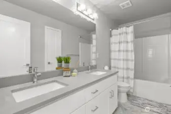 Then you will find the full bath with dual vanities and quartz counter tops.