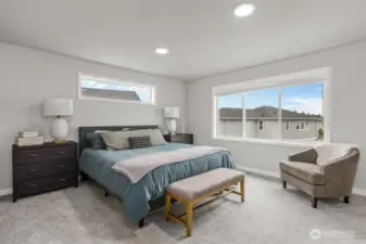 The spacious primary bed has room for all your bedroom furniture.