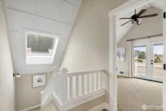 Up the stairs to the landing, ceiling fans help circulate warm or cool air.