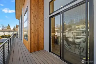 The deck off the living room spans the entire length of the home, with another slider located in front of the primary bedroom.