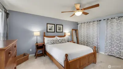 another angle of the Primary BR. A wall of closets behind the curtains.