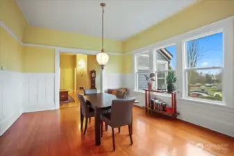 Abundant light streams into the dining room through a wall of windows.