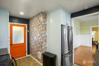 The orange door opens to the laundry area.