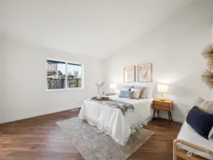 Primary bedroom with vaulted ceilings.