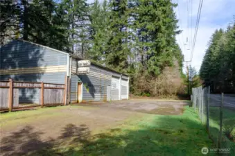 Huge shop on Wright Bliss with large bay doors, ventilation system, water storage for fire protection, fenced area behind shop for vehicle storage