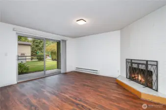 Living room features a large sliding door that fills the space with natural light and provides easy access to the outdoors.