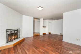 Living room features a cozy corner fireplace, adding warmth and charm to the space.
