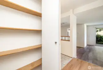 Hallway features a convenient storage closet, perfect for keeping essentials organized and out of sight.