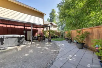 Stone pavers outline the concrete patio as an extension; perfect for container gardening.