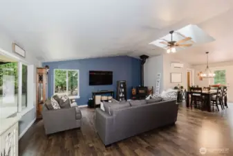 Great room with wood burning stove, skylights and Hickory flooring that runs throughout the entire home.