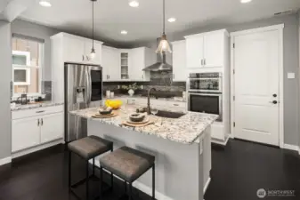 Kitchen with slab granite countertops and SS appliances