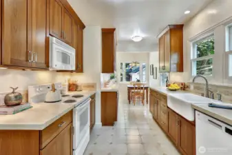 This well-lit kitchen is a highlight, featuring a generously sized breakfast nook that seamlessly connects to the property's rear deck, creating an inviting space for meals and outdoor enjoyment.