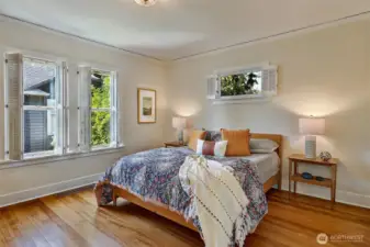 Main level bedroom with refinished fir floor and lots of light.