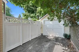 Fully fenced backyard with entrance next to the garage on the left.