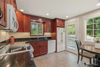 Kitchen with granite counters, eating nook and access to the rear deck.