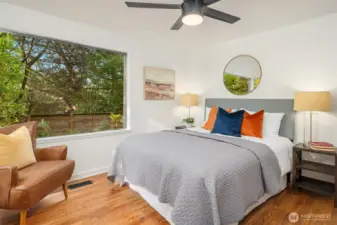 The primary bedroom has a large sunny windows.