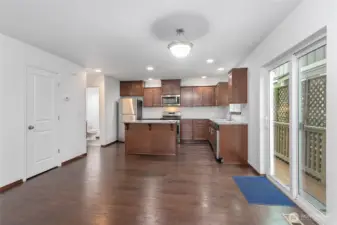 Step out the sliding glass door from the dining area to a side deck leading to the backyard.