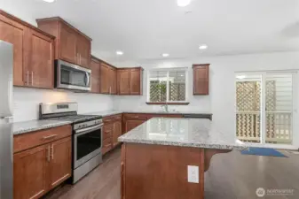 Handsome kitchen with plenty of storage, prep space, and stainless steel appliances.