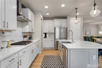 Any chef who loves to entertain will appreciate the kitchen’s updated quality Kitchen Aid appliances including double ovens and a gas range, a Samsung refrigerator, a large island with deep farmers-style sink, and incredible walk-in pantry with beverage cooler.
