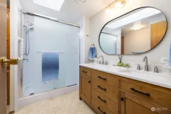 New double sink vanity and flooring in the bath.