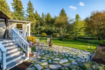 The yard is a nice size and well laid out with some lawn and lots of rhodies and trees on the edges.