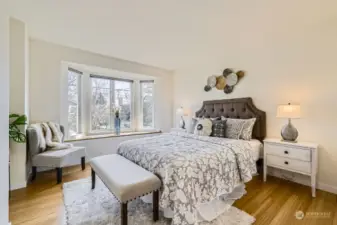 Upper floor south facing primary bedroom also has walk-in closet and renovated bath