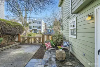 exit just off the kitchen directly to side yard / patio area - with additional fenced area out of photo for trash / recycling storage