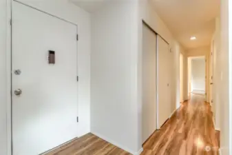 Entry and hallway to laundry room, hall bath, bedroom and primary suite